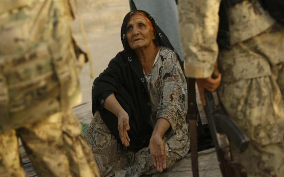 Strong Point Alizi, Afghanistan, Aug. 27, 2011: Officers with the Afghan National Civil Order Police speak with an Afghan woman during Operation Steel Lion III at Strong Point Alizi in Kandahar Province, Afghanistan. 

META TAGS: META TAGS: Operation Enduring Freedom; Helmand; War in Afghanistan; Wars on Terror