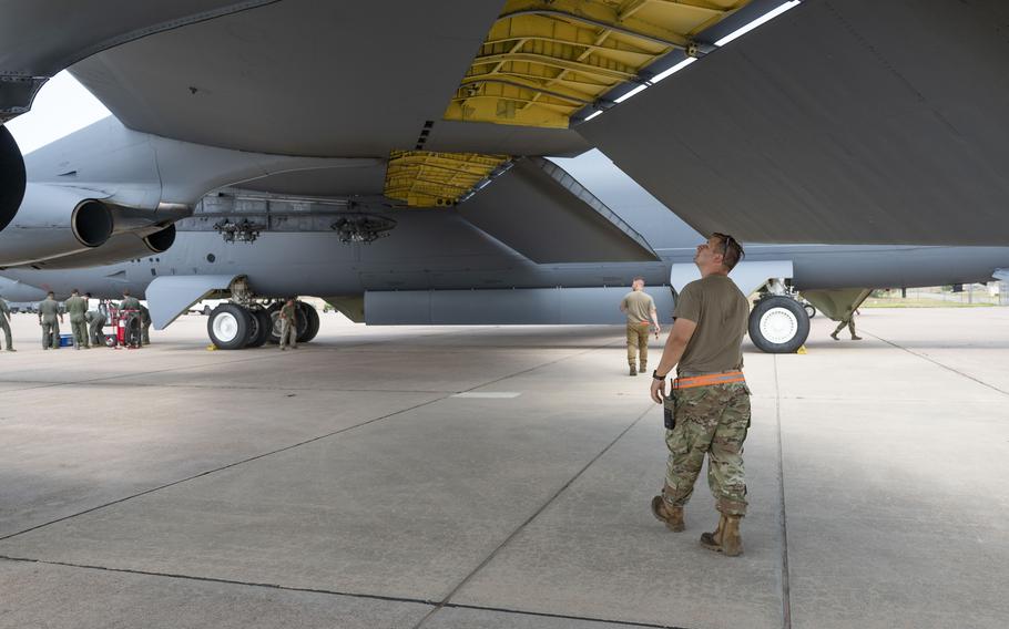 An airman from Minot Air Force Base, North Dakota, inspects the wing of a B-52 Stratofortress at Dyess Air Force Base, Texas, July 15, 2024.