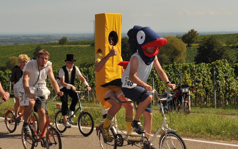 Cyclists in colorful costumes race their gearless folding bikes up Kalmit mountain on Saturday during the quirky and beloved Folding-Bike-Cup.