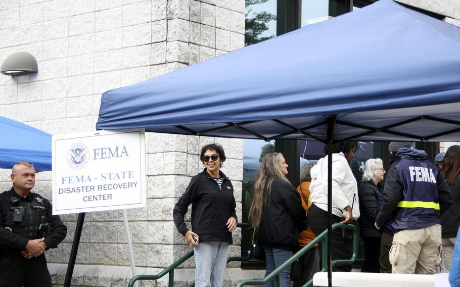 People gather at a FEMA Disaster Recovery Center at a high school in Asheville, N.C., Oct. 15, 2024.