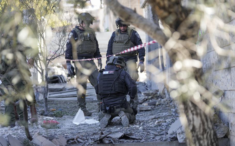 Members of the Israeli police bomb squad work at the site where one person was killed after a projectile launched from Lebanon slammed into Maalot-Tarshiha, northern Israel, Tuesday, Oct. 29, 2024. 