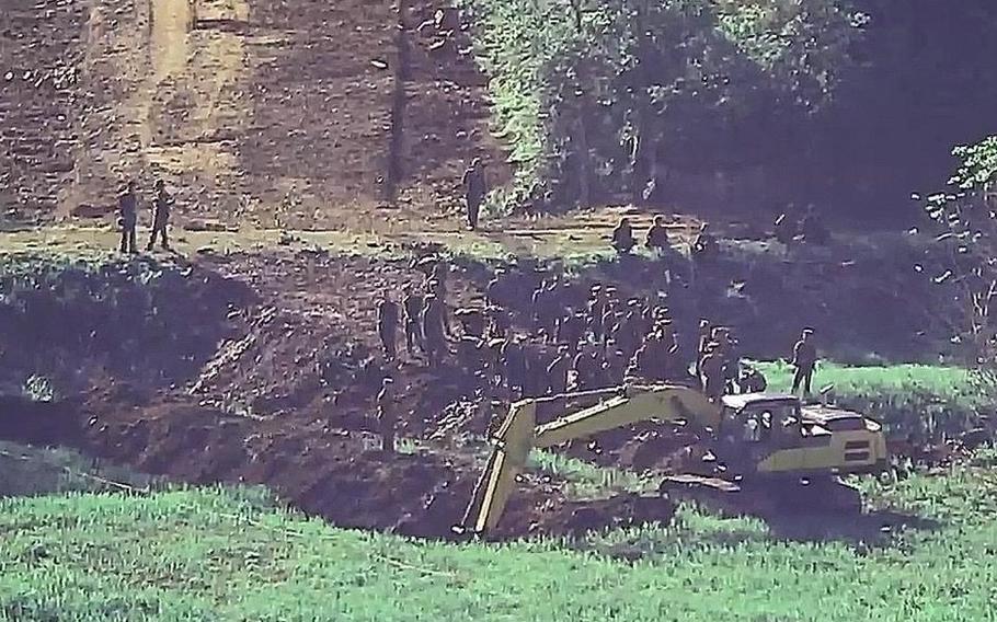 North Korean troops build a road near the DMZ in this undated photo provided by South Korea's Joint Chiefs of Staff on June 18, 2024.