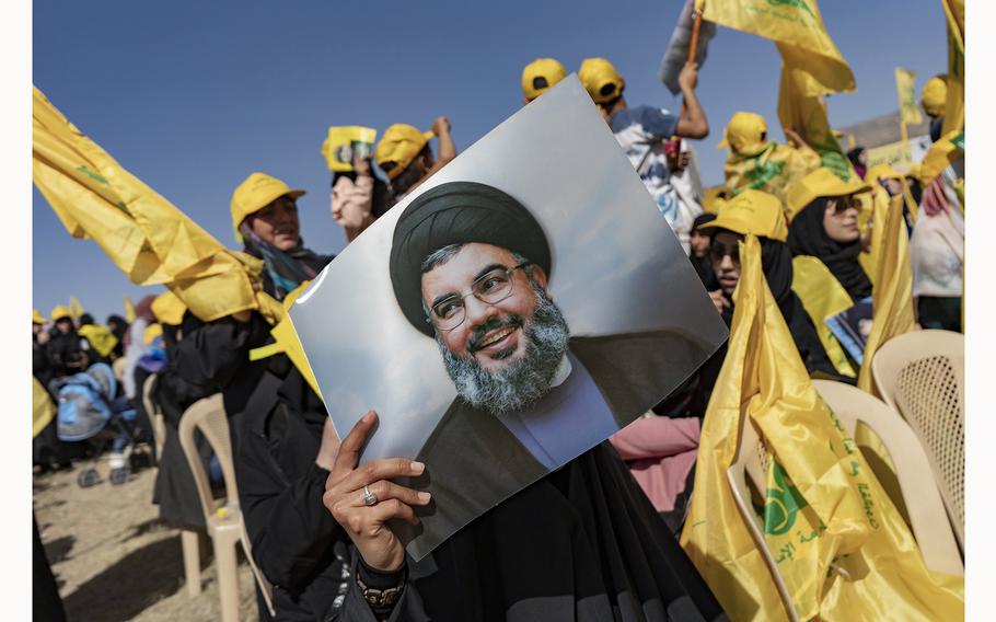 A woman holds a photo of Hassan Nasrallah, Secretary-General of Hezbollah in Baalbek in Bekaa Valley, Lebanon, on May 13, 2022, during a commemoration event.