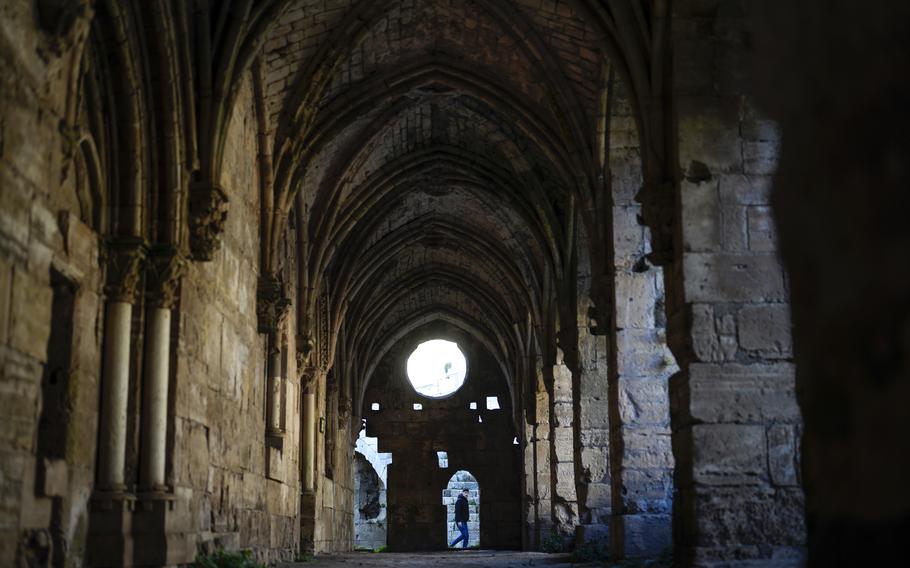 A man walks past the arches of the Knights’ Stables in Krak des Chevaliers castle.