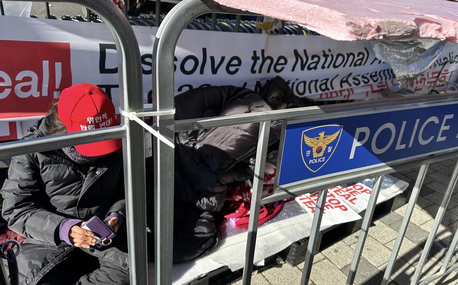 A supporter of impeached President Yoon Suk Yeol camps out in front of the presidential residence.