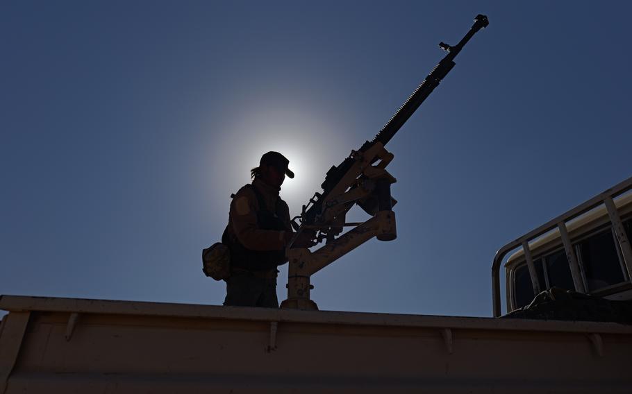 A U.S. soldier holds a weapon in Syria.