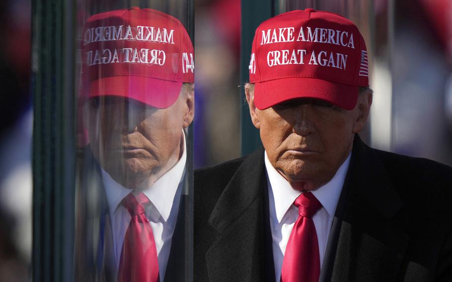 Republican presidential nominee former President Donald Trump is reflected in the bullet proof glass as he finishes speaking at a campaign rally in Lititz, Pa., Nov. 3, 2024. 