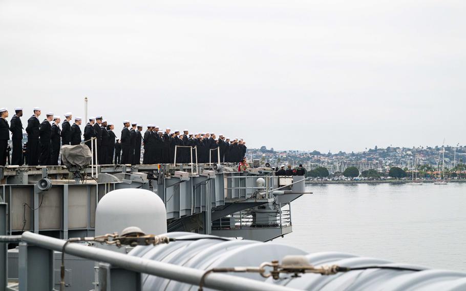 U.S. Navy Sailors man the rails on the flight deck