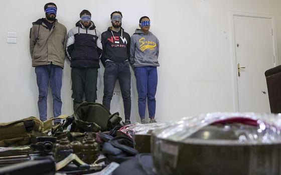 In this photo released by Syrian State TV, four suspects arrested in connection with an alleged plot by ISIS are shown standing against a wall in Damascus, Syria, Saturday, Jan. 11, 2025. Syrian intelligence officials, operating under the country's new de facto government, thwarted an attempt by ISIS to detonate a bomb at the Shiite shrine of Sayyida Zaynab in the Damascus suburb, according to state media reports on Saturday.(Syrian State TV via AP)