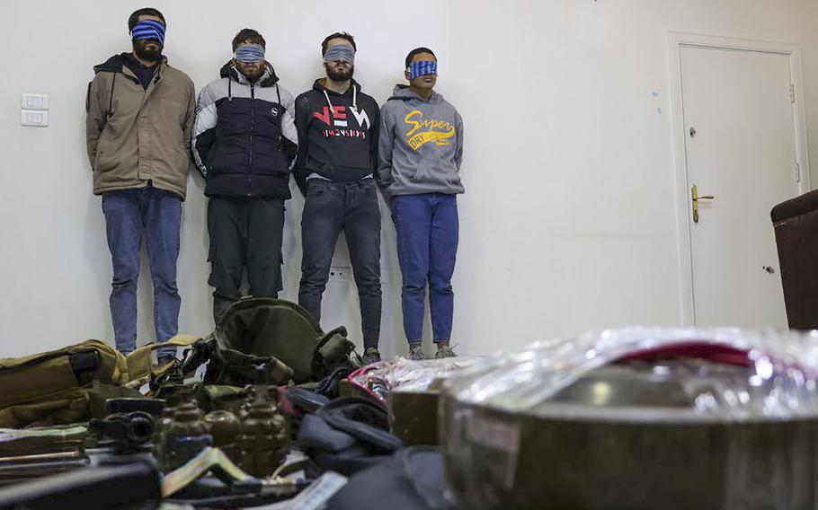 In this photo released by Syrian State TV, four suspects arrested in connection with an alleged plot by ISIS are shown standing against a wall in Damascus, Syria, Saturday, Jan. 11, 2025. 