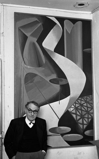 Man Ray stands before his work "Retour à la raison," (Return to reason). He painted an earlier rendition of the painting seen here in 1921 and returned to the motif in a three minute film in 1923. The version seen here was executed in 1939. 