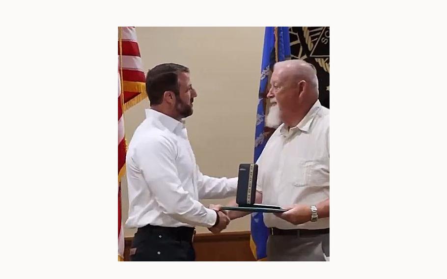A video screen grab shows Sen.  Markwayne Mullin, R-Okla., presenting a Purple Heart to Tim Vanover, the father of World War II veteran Eler Vanover, who survived the Bataan Death March in the Philippines.