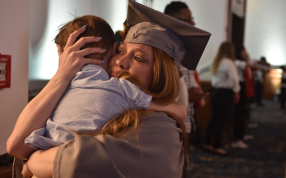 Marlee DaBrowski, an Army spouse, tearfully hugs her son