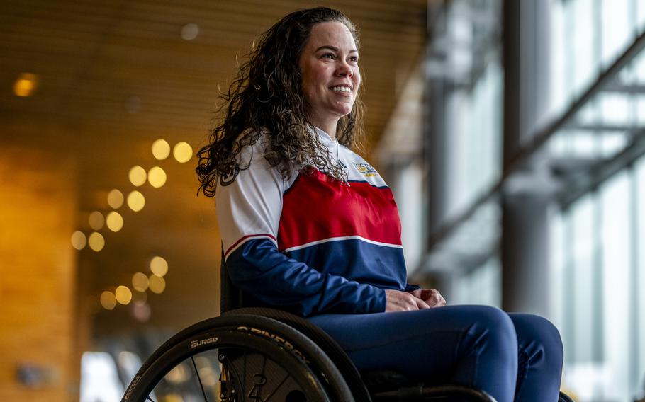 A competitor competes in indoor rowing poses for a portrait in her wheelchair