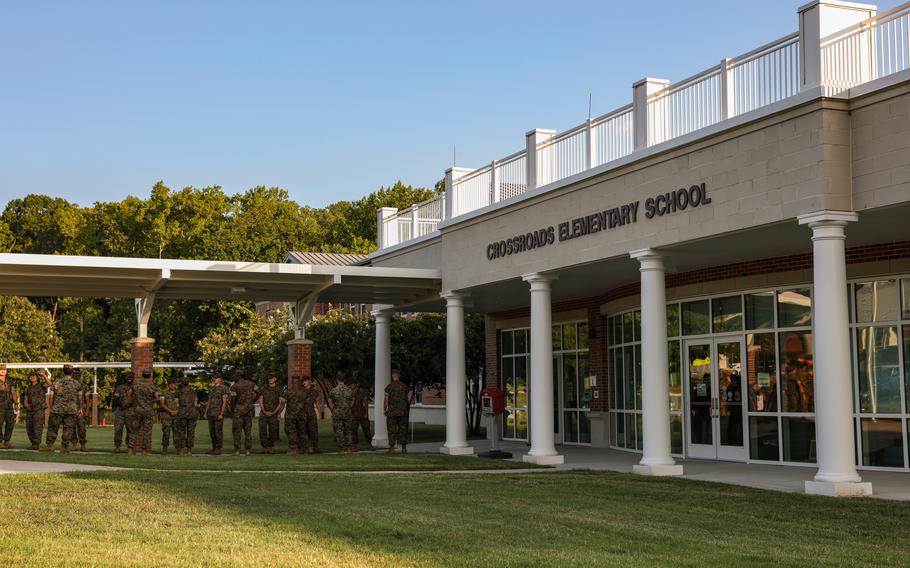 U.S. Marines wait to celebrate and encourage students during a back-to-school celebration at the Crossroads Elementary School on Marine Corps Base Quantico, Va., Aug. 21, 2024. 