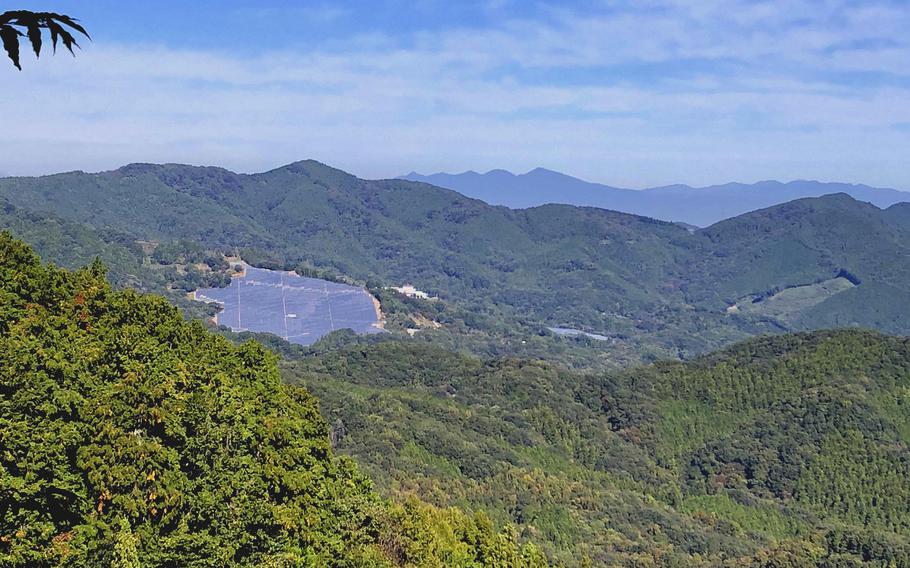 The view from Mount Hodo looks out over trees, a lake and toward distant hills.