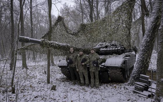 Tank commander Nazar, 23, stands with fellow soldiers Ruslan, 35, and Andrii, 37, at a fallback position in the Sumy region of Ukraine on Dec. 6. The troops, from Ukraine's 95th Brigade, were preparing for orders to return to Russia's Kursk region. MUST CREDIT: Serhiy Morgunov for The Washington Post