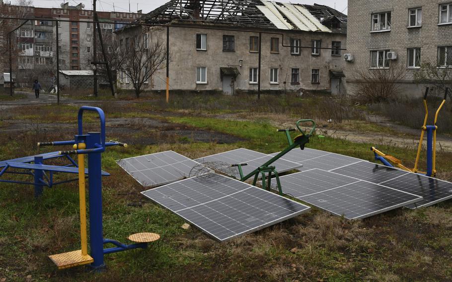 Solar panels in front of apartment buildings in Ukraine’s Donetsk region, Nov. 20, 2022.