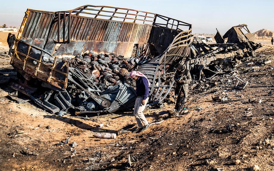 Syrians look for metal pieces and unexploded ammunition in the aftermath of an Israeli strike.