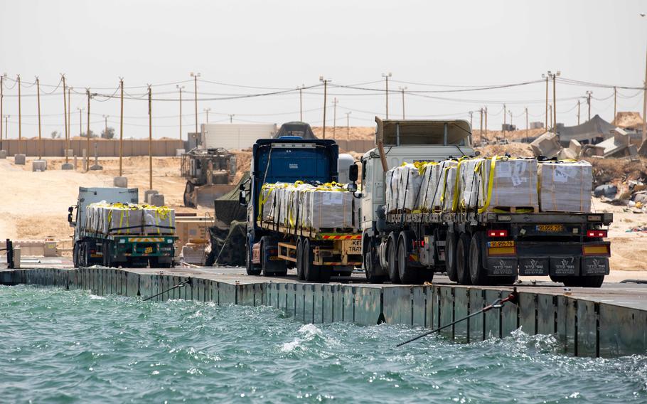 Humanitarian aid is transported along the U.S.-built temporary pier before entering the beach in Gaza on May 18, 2024.