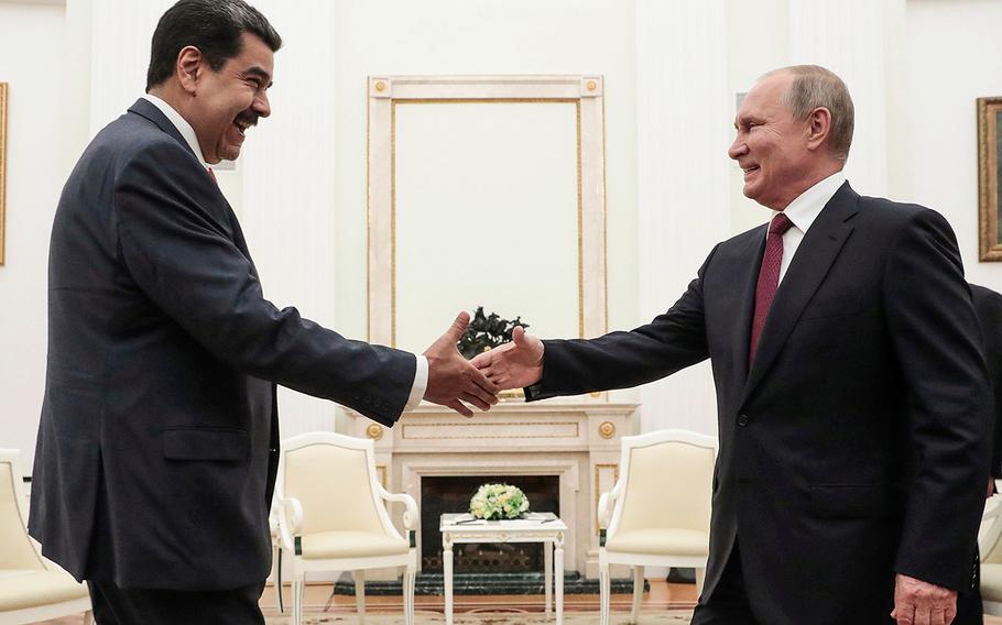 Russian President Vladimir Putin (right) is about to shake hands with Venezuelan President Nicolas Maduro during their meeting at the Kremlin in Moscow on Sept. 25, 2019. 