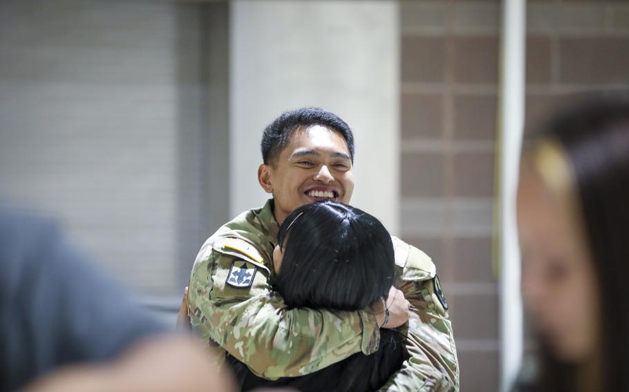 Alaska Army Guard Spc. Joel Francisco, an infantryman with Bravo Company, 1st Battalion, 297th Infantry Regiment, reunites with his family during a welcome home event at the Alaska National Guard Readiness Center on Joint Base Elmendorf-Richardson, Aug. 10, 2024. 