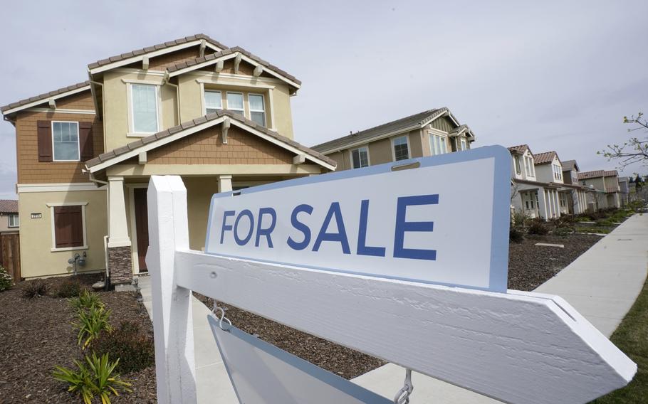 A for sale sign is posted in front of a home in Sacramento, Calif., March 3, 2022. 