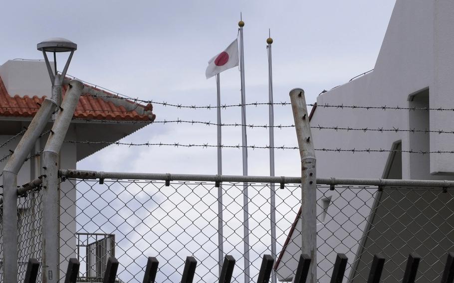 A Japanese flag flutters in the wind inside the Japan Self-Defense Forces (JSDF) base.