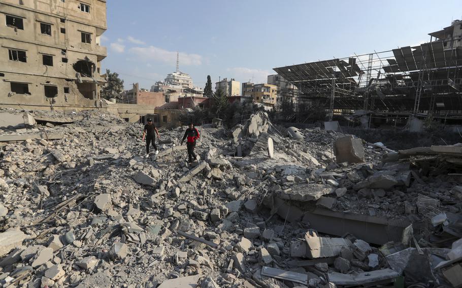 A couple of residents walk through the rubble of a building destroyed in an Israeli airstrike, Tyre, Lebanon, Nov. 9, 2024. 