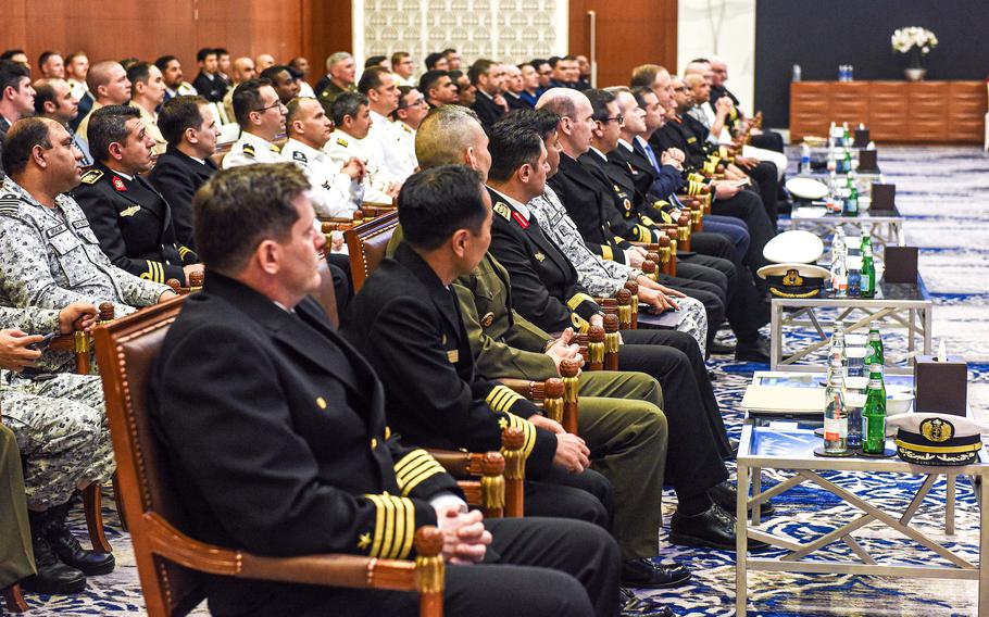 Rows of people in uniform seated for a ceremony.