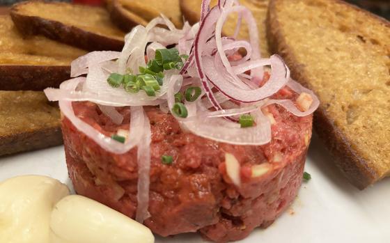 The beef tartare at Purkmistr in Pilsen, Czech Republic, is served with crispy bread and fresh garlic.