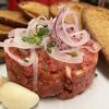 The beef tartare at Purkmistr in Pilsen, Czech Republic, is served with crispy bread and fresh garlic.