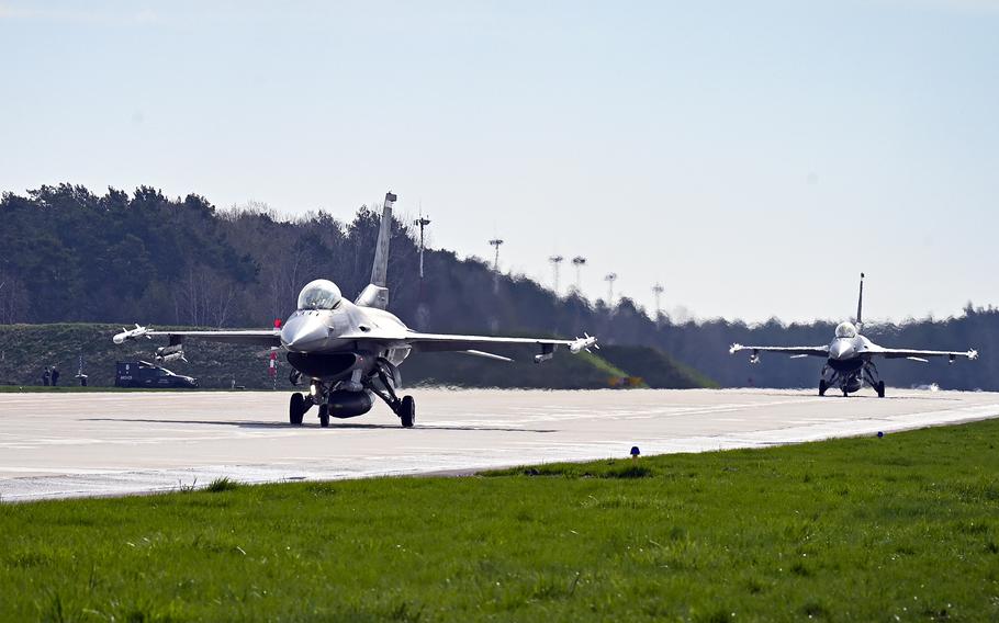 F-16 Fighting Falcons from the 52nd Fighter Wing, Spangdahlem Air Base, Germany, taxi on the flight line at Lask Air Base, Poland in 2021. Should former President Donald Trump return to the White House next year, analysts expect the U.S. military's focus to turn even further to China, with less emphasis on NATO and Europe.