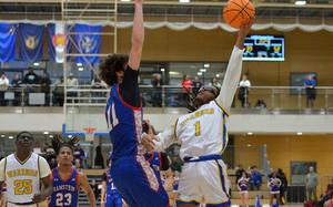 Wiesbaden's Jordan Thibodeaux shoots over Ramstein's Michael Gonzales in the boys Division I final at the DODEA-Europe basketball championships in Wiesbaden, Germany, Feb. 15, 2025. Wiesbaden beat Ramstein 58-54 to win the title.