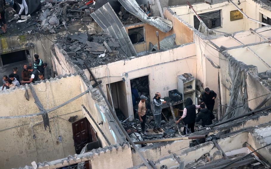 Palestinians check the destruction following Israeli bombardment in Rafah, in the southern Gaza Strip on Dec. 12, 2023, amid ongoing battles between Israel and the Palestinian militant group Hamas. 