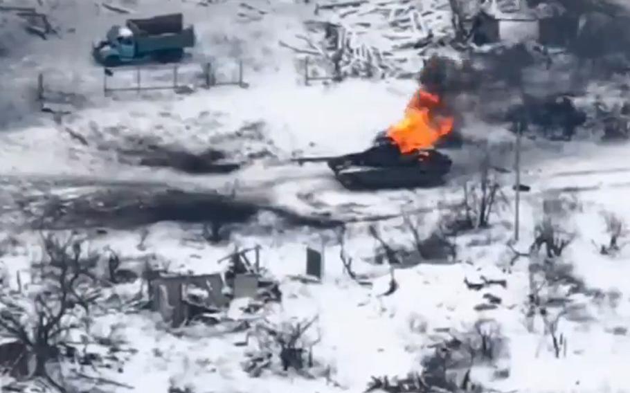 In a screenshot from a video posted on social media, a Russian armored vehicle burns after being hit by a Ukrainian drone. Gen. Valery Zaluzhny, Ukraine's top military commander, said the country's survival could hinge on a strategy shift that better exploits unmanned systems.