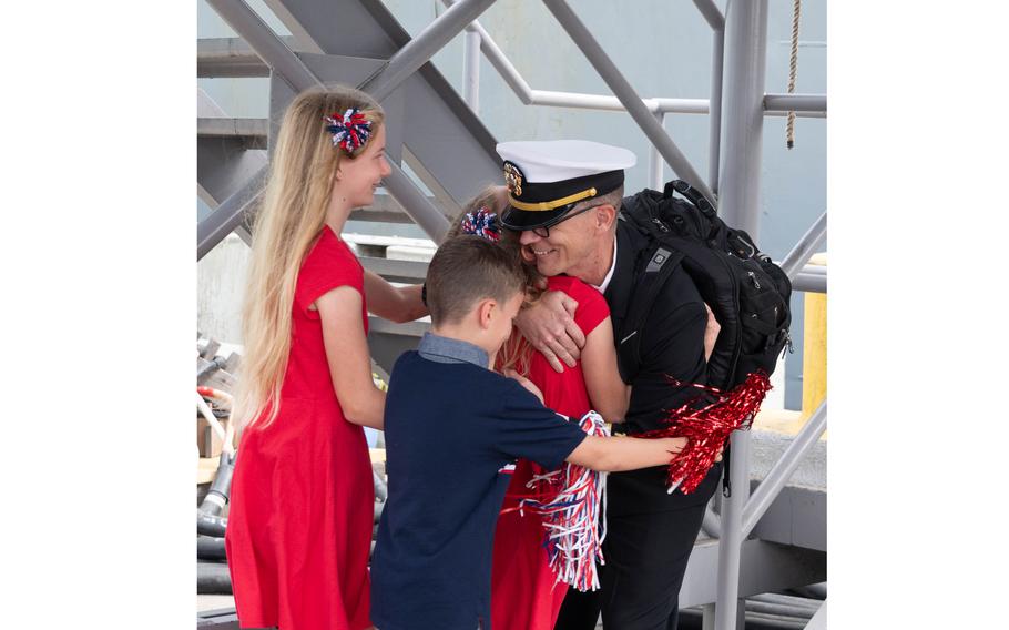 Lt. Zachary Vaughan shares the first hug with his children 