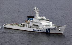 A Japanese coast guard vessel navigates through open water.