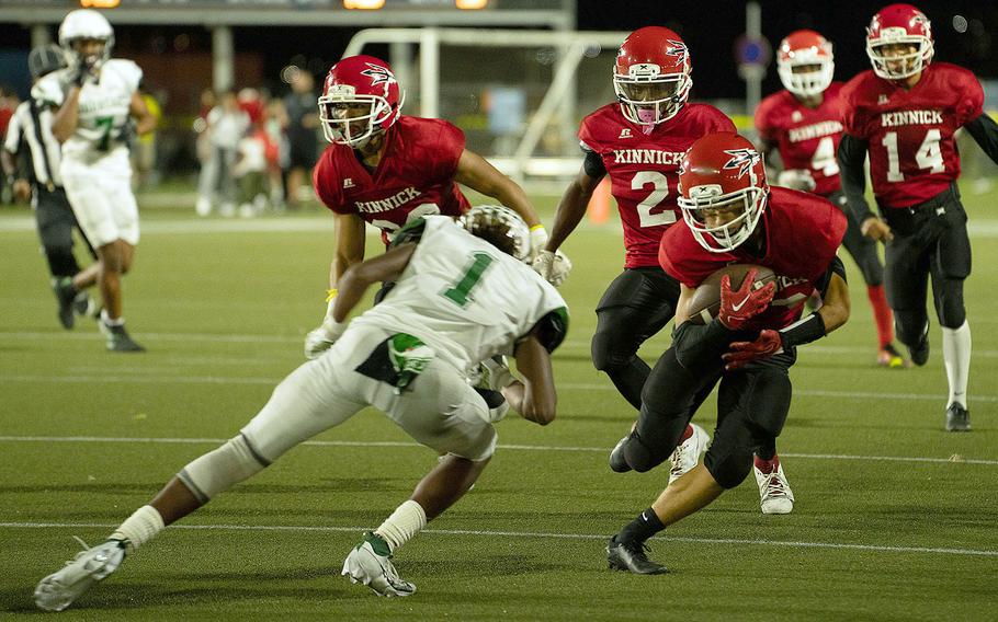 Nile C. Kinnick's Joseph Mauldin picks up a fumble and is met by Kubasaki's Carlos Cadet.