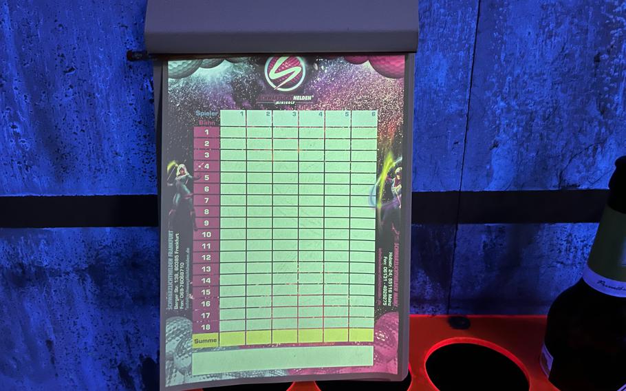 A miniature golf scorecard under blacklight.