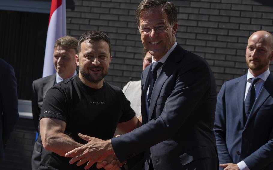 Ukrainian President Volodymyr Zelenskyy, left, is greeted by Dutch caretaker Prime Minister Mark Rutte in Eindhoven, Netherlands, Sunday, Aug. 20, 2023. Over the course of more than a dozen years at the top of Dutch politics, Mark Rutte got to know a thing or two about finding consensus among fractious coalition partners. Now he’s going to bring the experience of leading four Dutch multiparty governments to the international stage as NATO’s new secretary general.  (AP Photo/Peter Dejong, File)