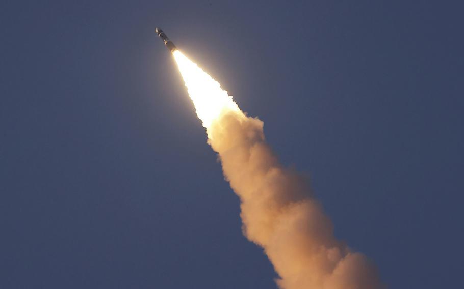 An intercontinental ballistic missile, seen from below, rises into the sky.