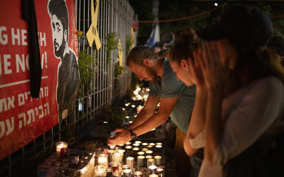 People light candles during a vigil in memory of slain hostage Hersh Goldberg-Polin in Jerusalem, Israel, Sunday, Sept. 1, 2024. (AP Photo/Leo Correa)