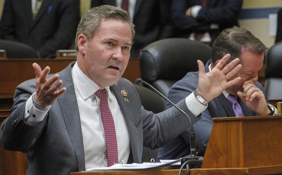 Rep. Mike Waltz gestures with his hands as he speaks during a congressional hearing.