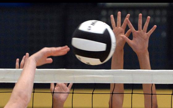 A battle at the net in volleyball.