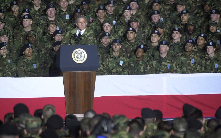 President George W. Bush talks to troops and family members