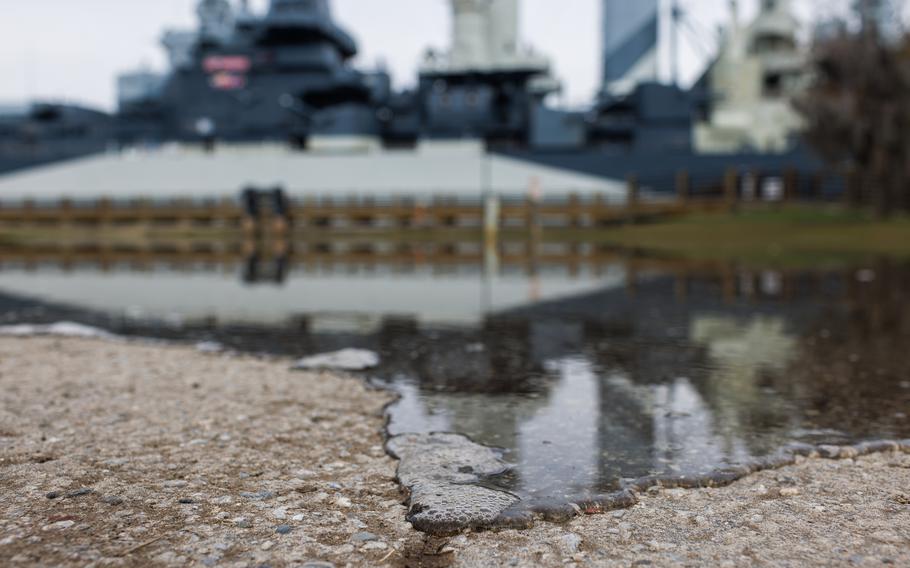 Water from the Cape Fear River trickles into the parking lot at the USS North Carolina Battleship National Historic Site on Nov. 28, 2023.