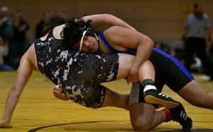 Hohenfels' Nehemiah Baleto slams Stuttgart's Alex Levardi to the mat during the 215-pound final at the Stuttgart sectional tournament on Feb. 1, 2025, at Stuttgart High School in Böblingen, Germany.