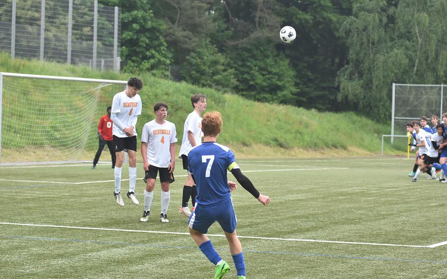 Brussels' Cade Wedekind sends a free kick past a wall of Spangdalem defenders towards a group of onrushing players in the Sentinels' 2-1 victory Tuesday, May 21, 2024, at the DODEA European Division III boys soccer championships at Landstuhl, Germany.