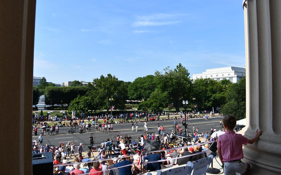 A young buy surveys the gathering crowd from the steps of the National Archives before its Independence Day event begins, as seen on July 4, 2024.